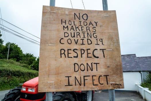 PORTNOO, COUNTY DONEGAL / IRELAND - APRIL 10 2020 : Sign warning no holiday makers during covid 19. Respect dont infect.