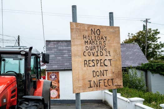 PORTNOO, COUNTY DONEGAL / IRELAND - APRIL 10 2020 : Sign warning no holiday makers during covid 19. Respect dont infect.