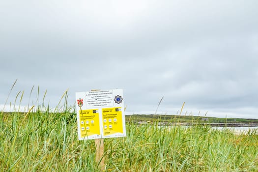 PORTNOO, COUNTY DONEGAL / IRELAND - JUNE 17 2020: Sign explaining the 2m social distancing rule at the beach.