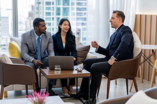 African businessman present start up project to expert investor. Group of multicultural business team solving problems, discussing business idea with skyscraper at modern business lounge. Ornamented