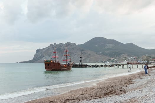 Sailing ship sailing to the shore, marine tourism. Beach holidays on the Black Sea. Fabulous moments of a sunny day