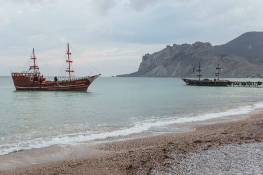 Sailing ship sailing to the shore, marine tourism. Beach holidays on the Black Sea. Fabulous moments of a sunny day