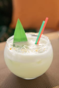 Cold coconut cocktail in a low glass glass. The concept of cold summer drinks.