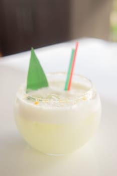 Cold coconut cocktail in a low glass glass. The concept of cold summer drinks.