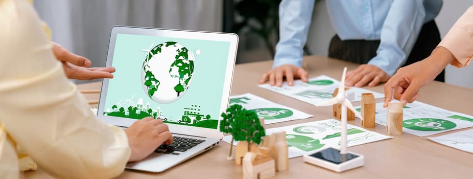 Green city logo displayed on a laptop at a green business meeting. Team presenting green design to customer. ESG environment social governance and Eco conservative concept. Closeup. Delineation.