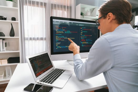 IT developer selecting by point on coding online software development information on pc comparing with laptop screen of new code program's update version firmware overall system project. Pecuniary.