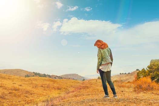 Beauty woman outdoors enjoying nature. Women enjoying nature in meadow. Fresh morning air summer Field at sunrise.