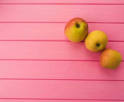 Summer abstract background mockup template free copy space for text pattern sample top view above on pink wooden board. blank empty area for inscription. fresh red apples organic fruits vegetarian