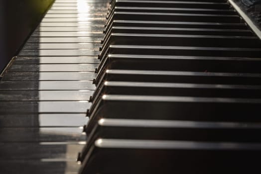 Piano keys side view with shallow depth of field. Classic grand piano keyboard background, Space for text, Selective focus.