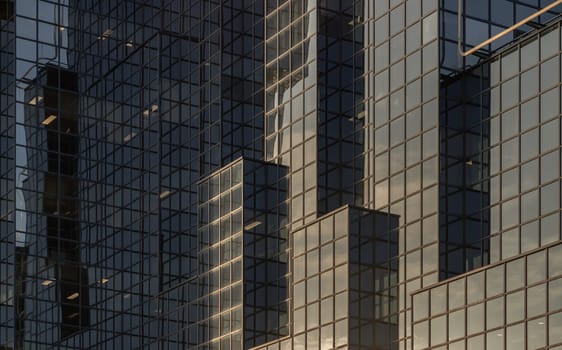 London, UK - Feb 27, 2024 - Architecture exterior of Modern building with many glass windows reflecting the sky. Northern & Shell Headquarters on the bank of the River Thames, Concept of successful business, Space for text, Selective focus.