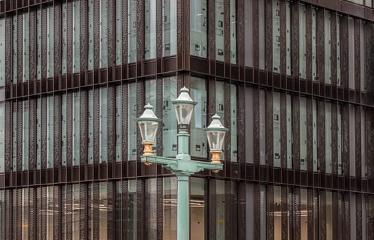 London, UK - Feb 27, 2024 - View of Decorative street lamp on Southwark bridge against the background of Modern building. Space for text, Selective focus.
