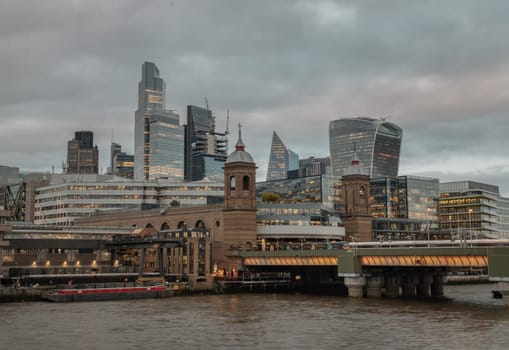 London, UK - Feb 27, 2024 - Beautiful view of Skyscrapers and The cannon street railway bridge in the business district Looking through Southwark bridge over River thames in city of london. Architectural modern buildings, Space for text, Selective Focus.