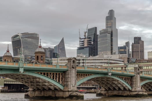 London, UK - Feb 27, 2024 - Beautiful view of Skyscrapers and Southwark bridge in the business district over River thames in city of london. Architectural modern buildings, Space for text, Selective Focus.
