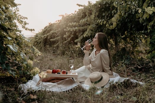 Picnic and wine tasting at sunset in the hills of Italy, Tuscany. Vineyards and open nature in the summer. Romantic dinner, fruit and wine.