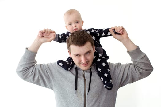Cheerful father playing and carrying infant son on shoulders isolated on white.