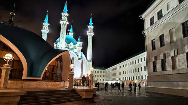 Beautiful white mosque with minarets against dark cloudy sky in night or evening. Ramadan Holiday