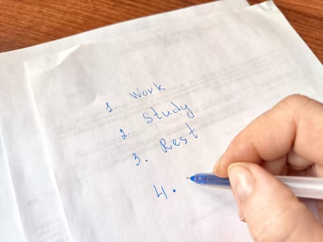 Handwriting Personal To-Do List on Paper. Close-up of a handwriting a to-do list
