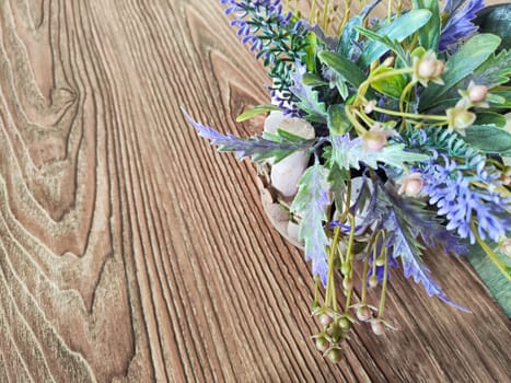 Colorful bouquet of gentle spring flowers placed on rustic wooden table. Background, place for text, copy space