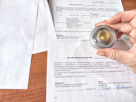 Kirov, Russia - February 16, 2024: A hand stamping seal on an official form. Official Document Being Stamped by a Person at a Wooden Desk