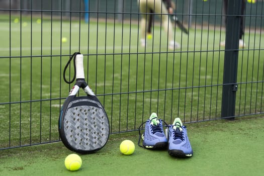professional paddle tennis racket with natural lighting on blue background. Horizontal sport theme poster, greeting cards, headers, website and app. High quality photo