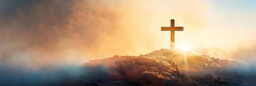 Christian cross on the top of the mountain at sunset.
