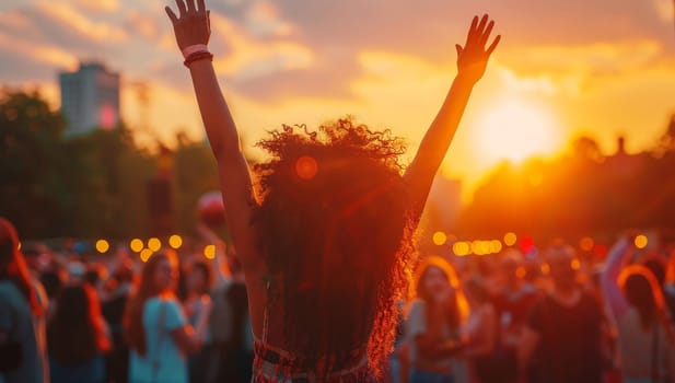 Back view of young african american woman dancing at music festival