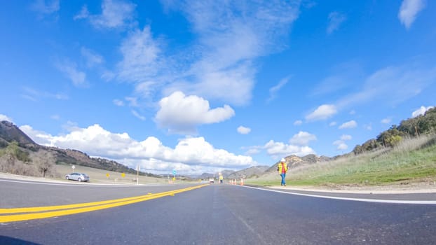 Santa Maria, California, USA-December 6, 2022-Vehicle is cruising along the Cuyama Highway under the bright sun. The surrounding landscape is illuminated by the radiant sunshine, creating a picturesque and inviting scene as the car travels through this captivating area.