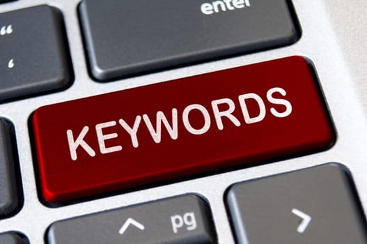 Keywords text on red laptop keyboard button. Lead generation and keywords search concept.