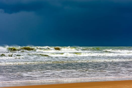 Dark rain clouds over the waters of Sargi beach in Serra Grande on the coast of Bahia