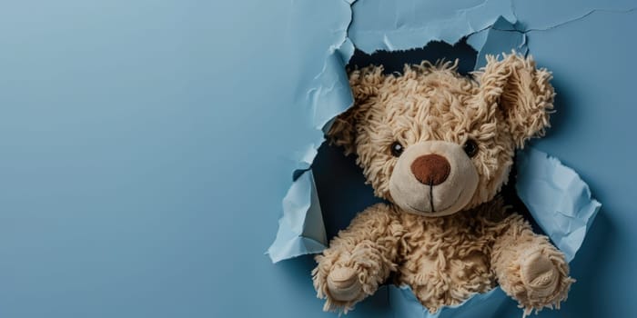 Close up view picture of the hollow blue hole on the the wall that show the teddy stay inside the wall that has been made from some material yet still can be break to look through other side. AIGX03.