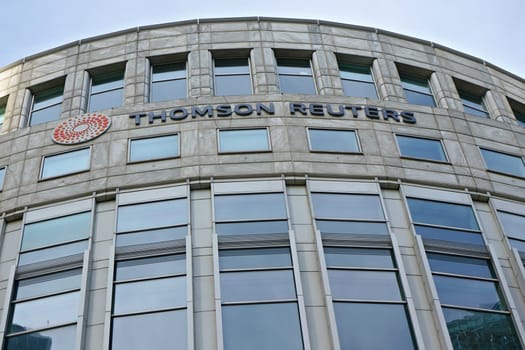 London, United Kingdom - February 03, 2019: Sun shines on Thomson Reuters offices building at Canary Wharf in UK capital. TR Group is Canadian multinational mass media and information firm