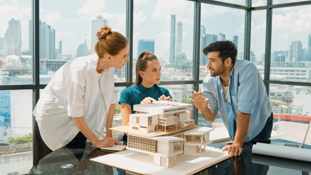 Smart architect team discussion about house design while handsome male worker present idea by using laptop. Group of professional engineer sharing, brainstorming design. Business design. Tracery