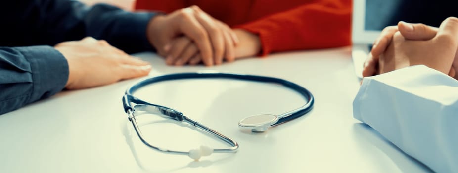 Couple attend fertility or medical consultation with gynecologist at hospital as family planning care for pregnancy. Husband and wife consoling each other through doctor appointment. Panorama Rigid