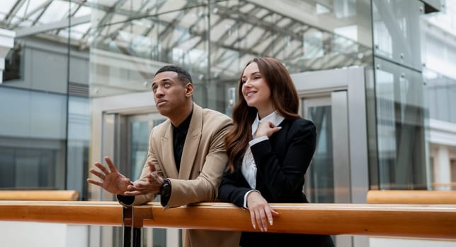 Happy young entrepreneurs smiling while working together in a modern workspace. High quality photo