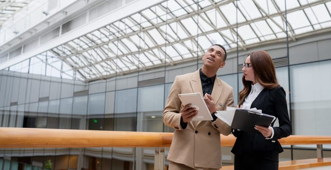 Happy young entrepreneurs smiling while working together in a modern workspace. High quality photo