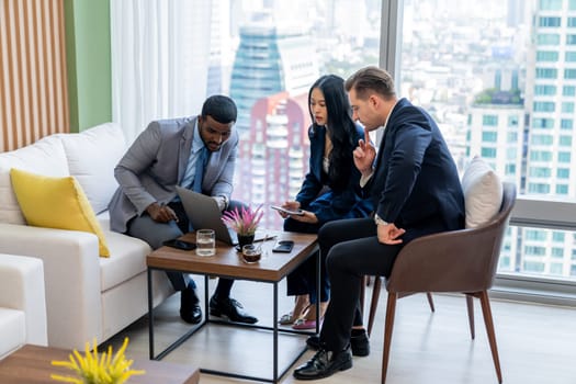 African businessman present start up project to expert investor. Group of multicultural business team solving problems, discussing business idea with skyscraper at modern business lounge. Ornamented