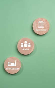 ESG concepts for sustainable environment, society and governance Businesses are environmentally responsible, A circular wooden board with the abbreviation ESG printed on a green background.