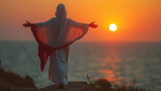 Muslim man in a white robe with a red shawl on his head against the background of the setting sun.