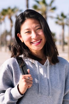 portrait of young asian college girl dressed in casual clothes smiling looking at camera, student lifestyle concept