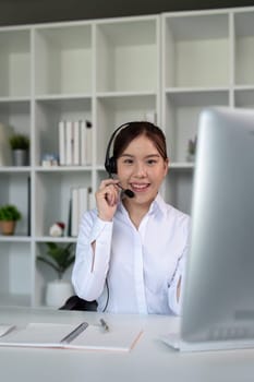 Call center friendly woman asian in office for customer service, technical support and advice, contact and communication with employee operator in help desk agency.