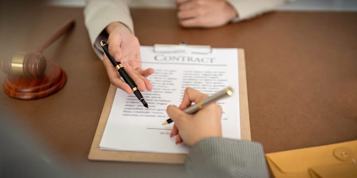 Company hired the lawyer office as a legal advisor and draft the contract so that the client could signs the right contract. Contract of sale was on the table in the lawyer office.