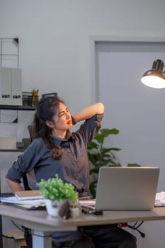 Young businesswoman who is tired from sitting for a long time in the office.