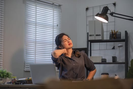 Young businesswoman who is tired from sitting for a long time in the office.