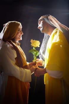 A couple in love or a married couple in stylized Eastern clothing from Israel, Palestine, Iran, Pakistan together. Tender photo session in the style of the Middle East and the Bible