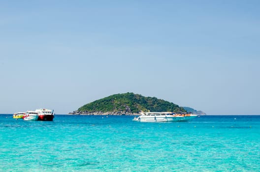 Tropical islands of ocean blue sea water and white sand beach at Similan Islands with famous Sail Rock, Phang Nga Thailand nature landscape. High quality photo