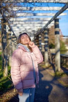 Winter Fun in Bitigheim-Bissingen: Beautiful Girl in Pink Jacket Amidst Half-Timbered Charm. Step into the festive winter spirit with this captivating image of a lovely girl in a pink winter jacket standing in the archway of the historic town of Bitigheim-Bissingen, Baden-Württemberg, Germany. The backdrop features charming half-timbered houses, enhanced by warm vintage photo processing, creating a delightful scene of winter joy and architectural beauty.