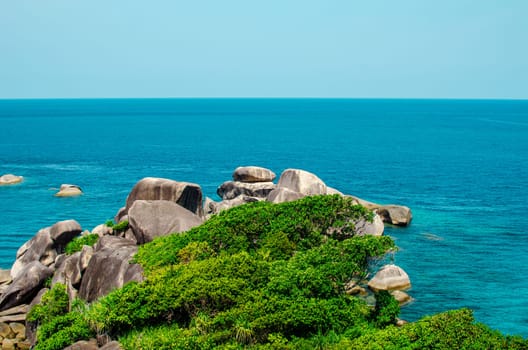 Rocks and stone beach Similan Islands with famous Sail Rock, Phang Nga Thailand nature landscape.