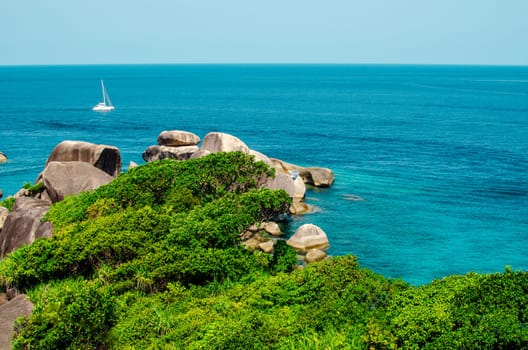 Tropical islands of ocean blue sea water and white sand beach at Similan Islands with famous Sail Rock, Phang Nga Thailand nature landscape. High quality photo