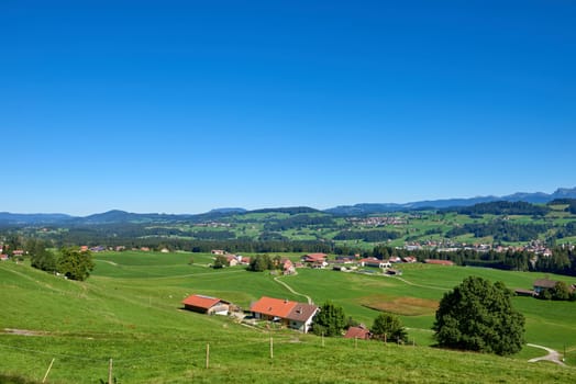 Alpine Foothills Charm: Rural Mountainside Living with Farmer's Homesteads. Mountain Countryside Serenity Captured: Farmer's Dwellings, Pastures, and the Sky Above. Nature's Tapestry Defined: Eco-Friendly Living in the Alpine Highlands. Rural Elegance Revealed: Alpine Homesteads, Pastures, and the Skies of Conservation. Alpine Horizon Explored: Farmers' Dwellings, Green Pastures, and Environmental Harmony