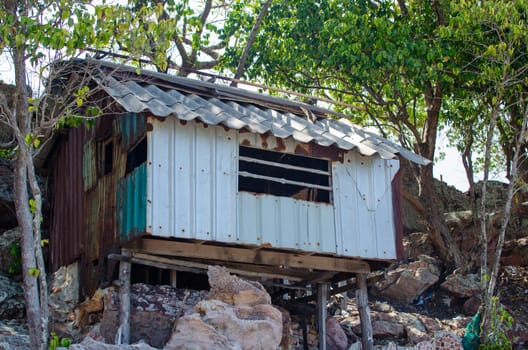 Old abandoned house on the edge of a cliff in the jungle.